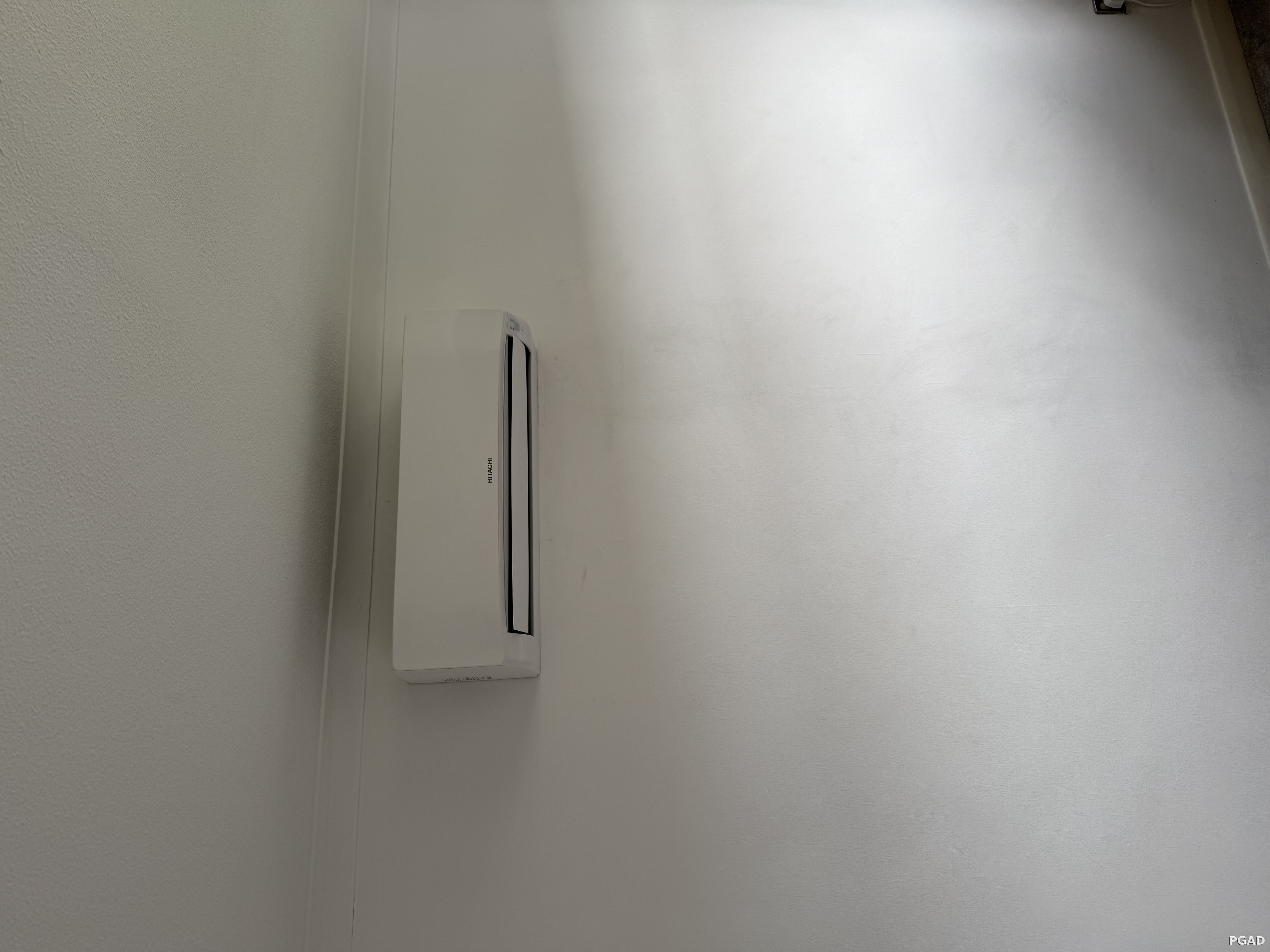 Wall-mounted Hitachi air conditioning unit maintained by PGAD