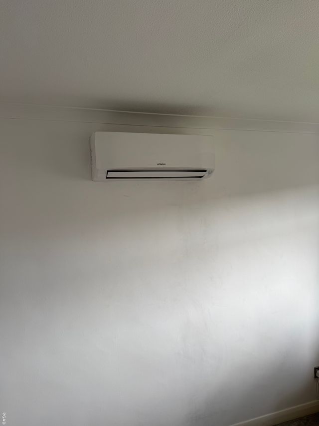 Wall-mounted Hitachi air conditioning unit maintained by PGAD